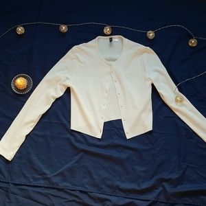 Cropped white long sleeve button up shirt.
